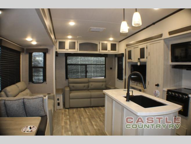 This living room is spacious and features plenty of seating for guests.